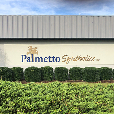 Palmeto Synthetics logo on side of their building